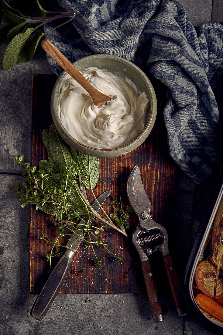 Fresh herbs and cottage cheese on wooden board