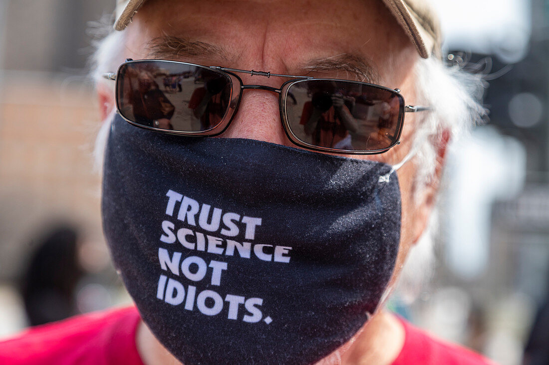 Man wearing a face mask with a message