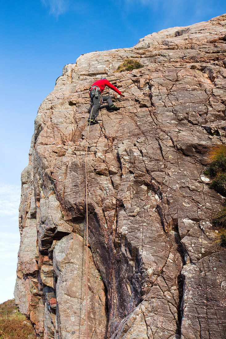 Rock climber on a crag, Scotland, UK