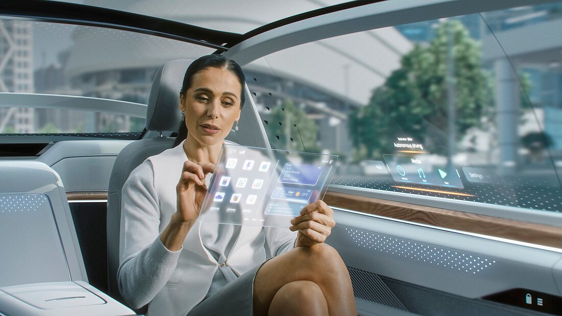 Woman using a tablet in an autonomous car