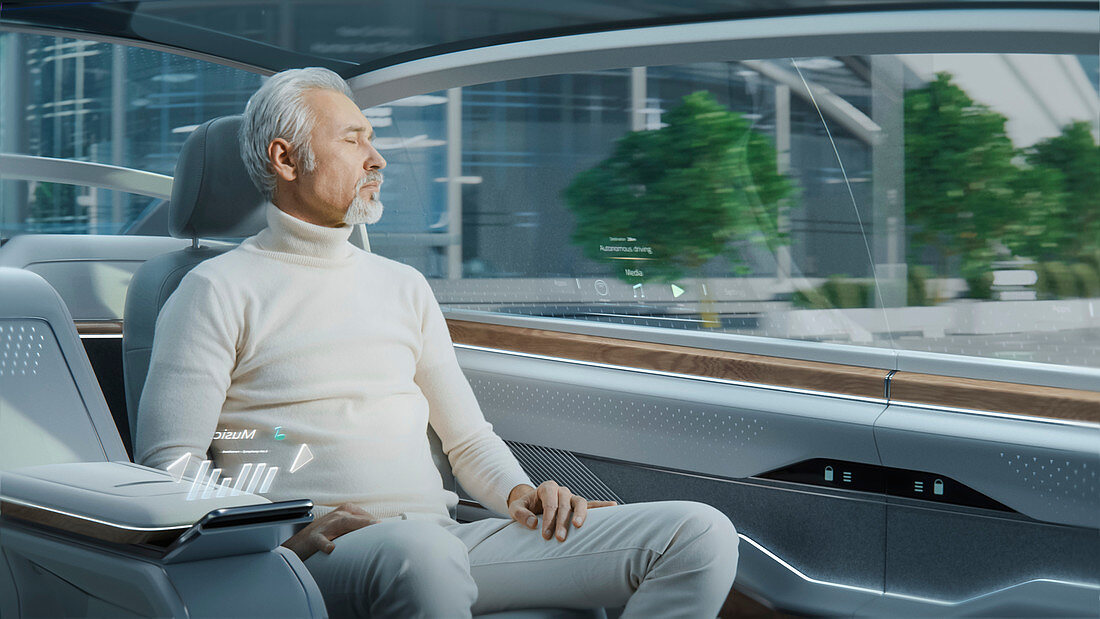 Man looking out of the window of an autonomous car