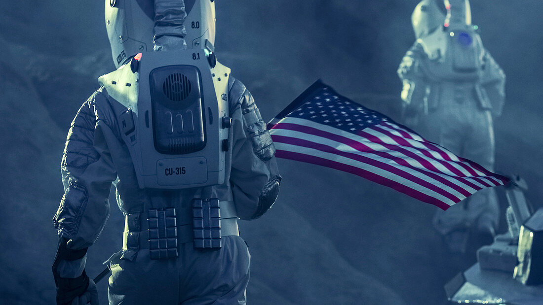 Astronauts exploring an alien planet carrying a US flag