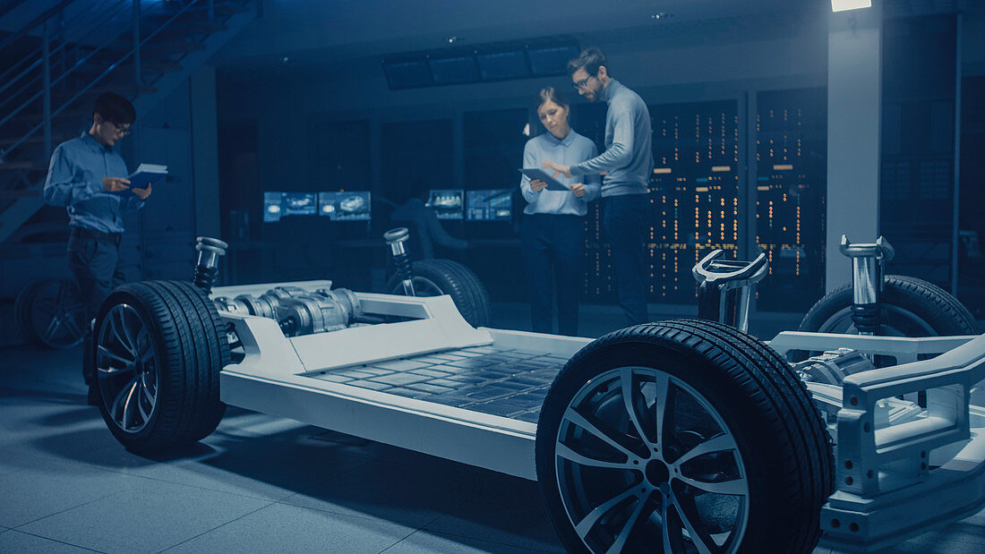 Automobile engineers working on an electric car prototype