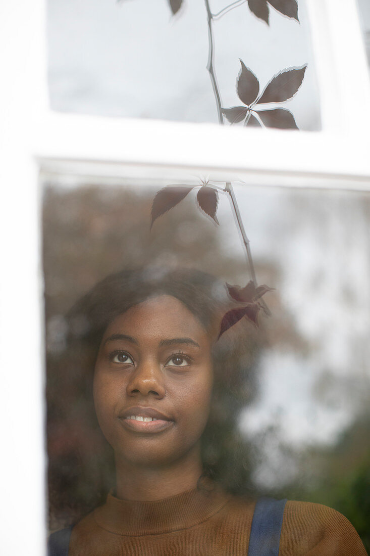 Young woman looking out window