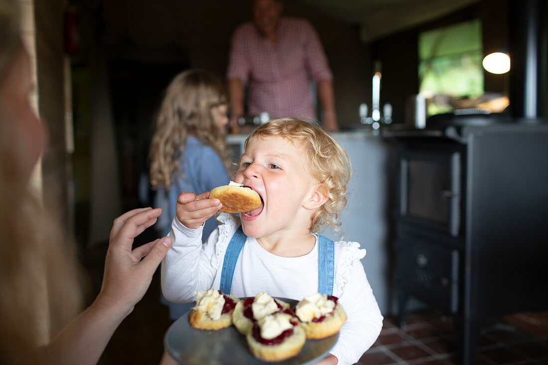 Girl eating sweet pastry at home