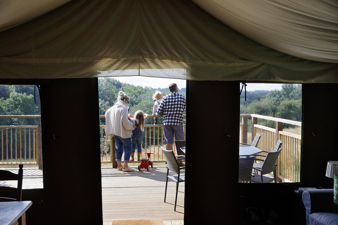 Family on a yurt tent balcony