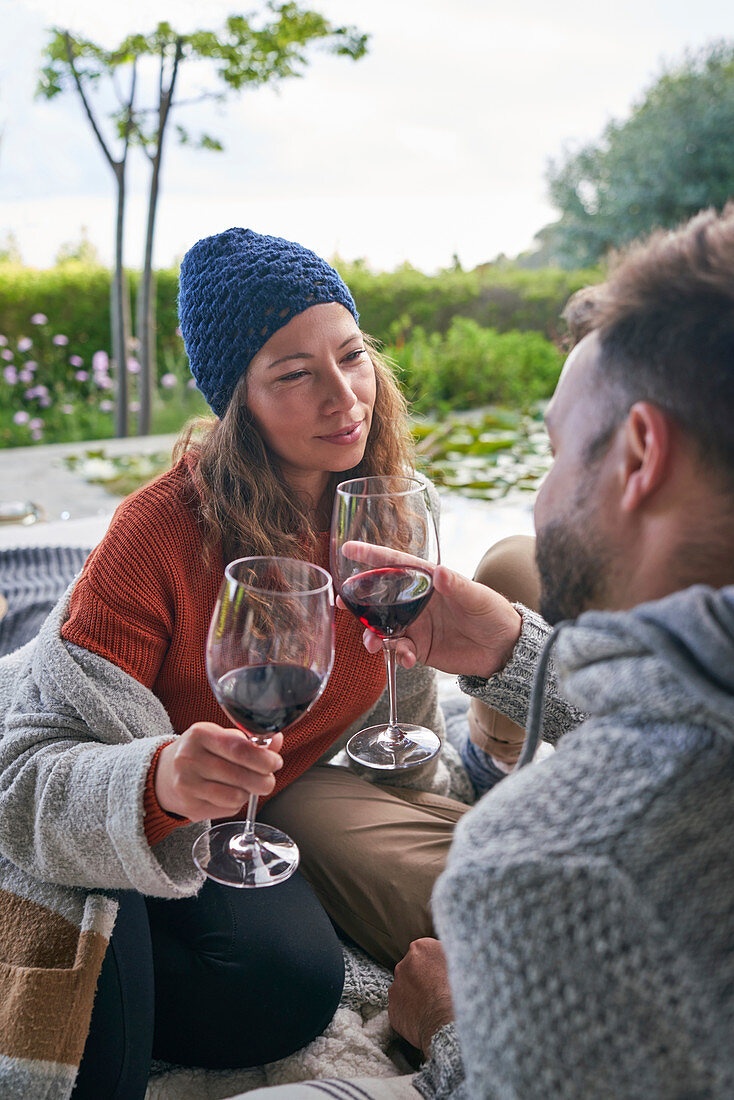 Couple drinking red wine on patio