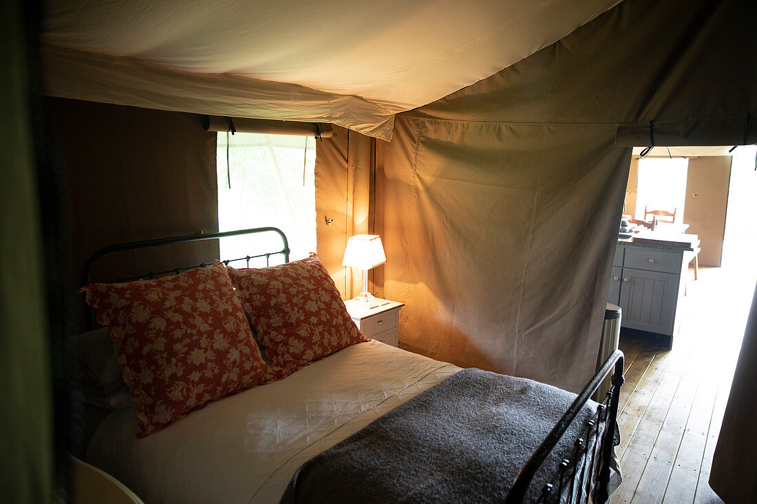 Bed and lamp in luxury camping yurt