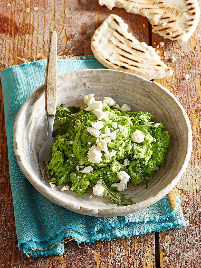 Pea dip with feta cheese and bread loaf