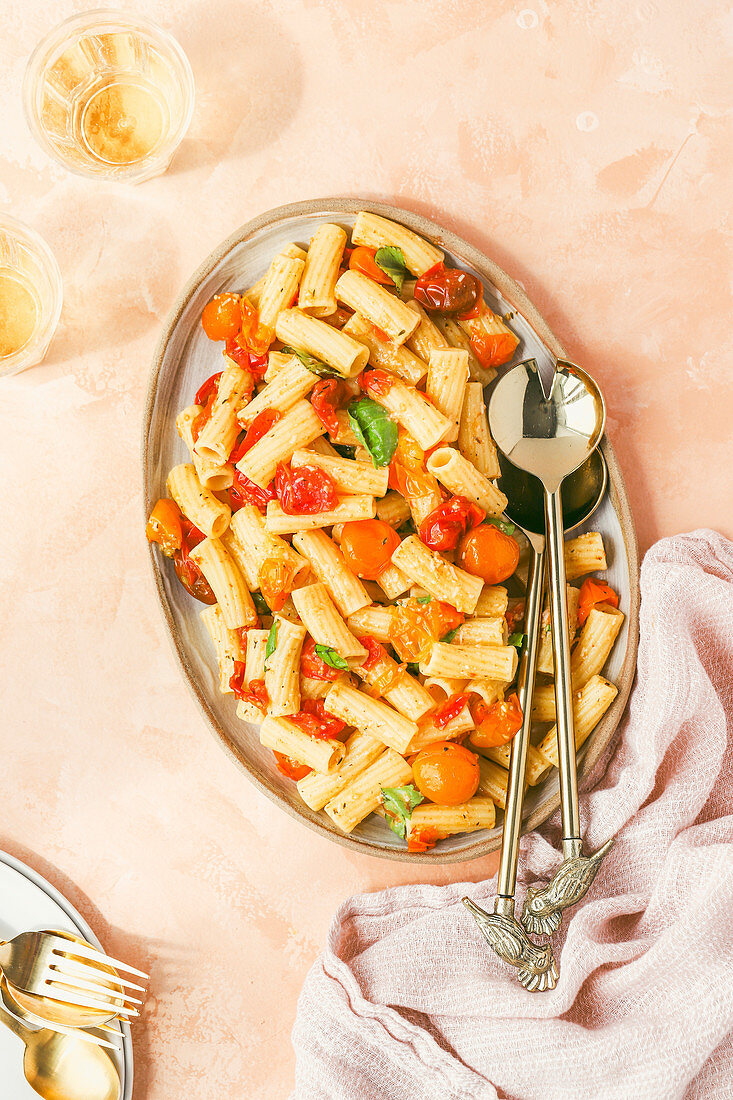 Rigatoni pasta with blistered tomatoes and fresh basil
