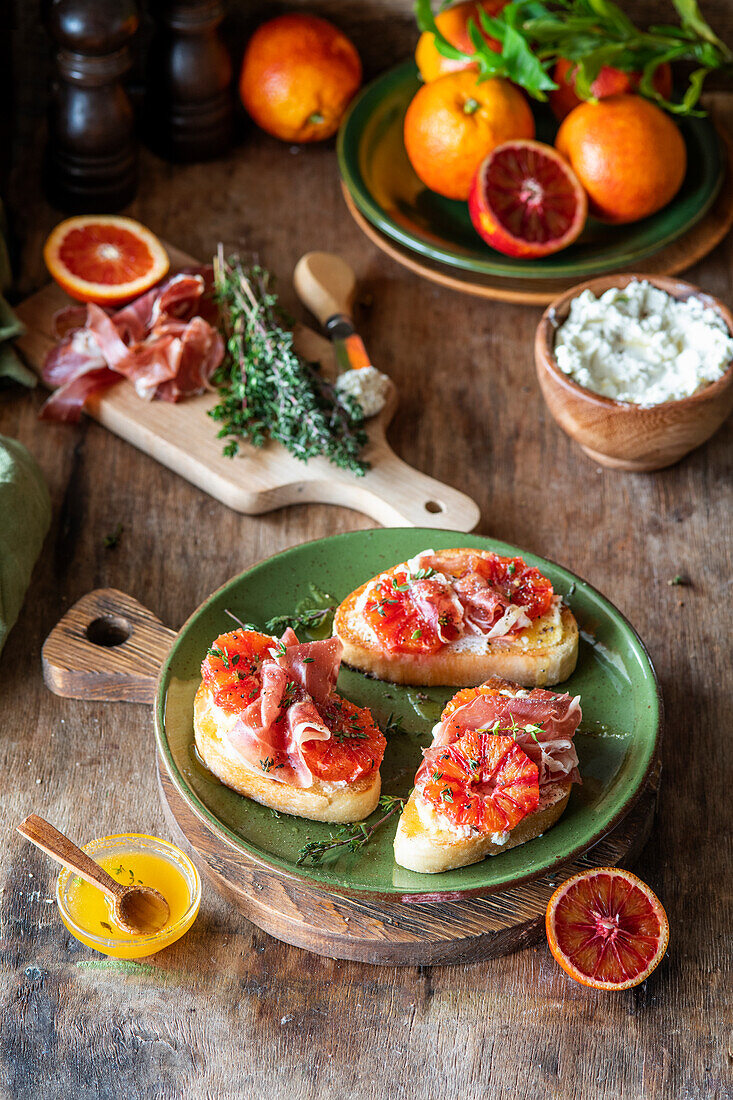 Blood orange bruchetta with cream cheese and proscuitto