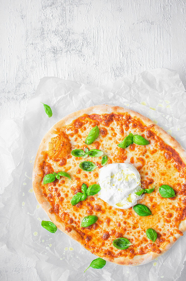 Pizza with burrata and fresh basil