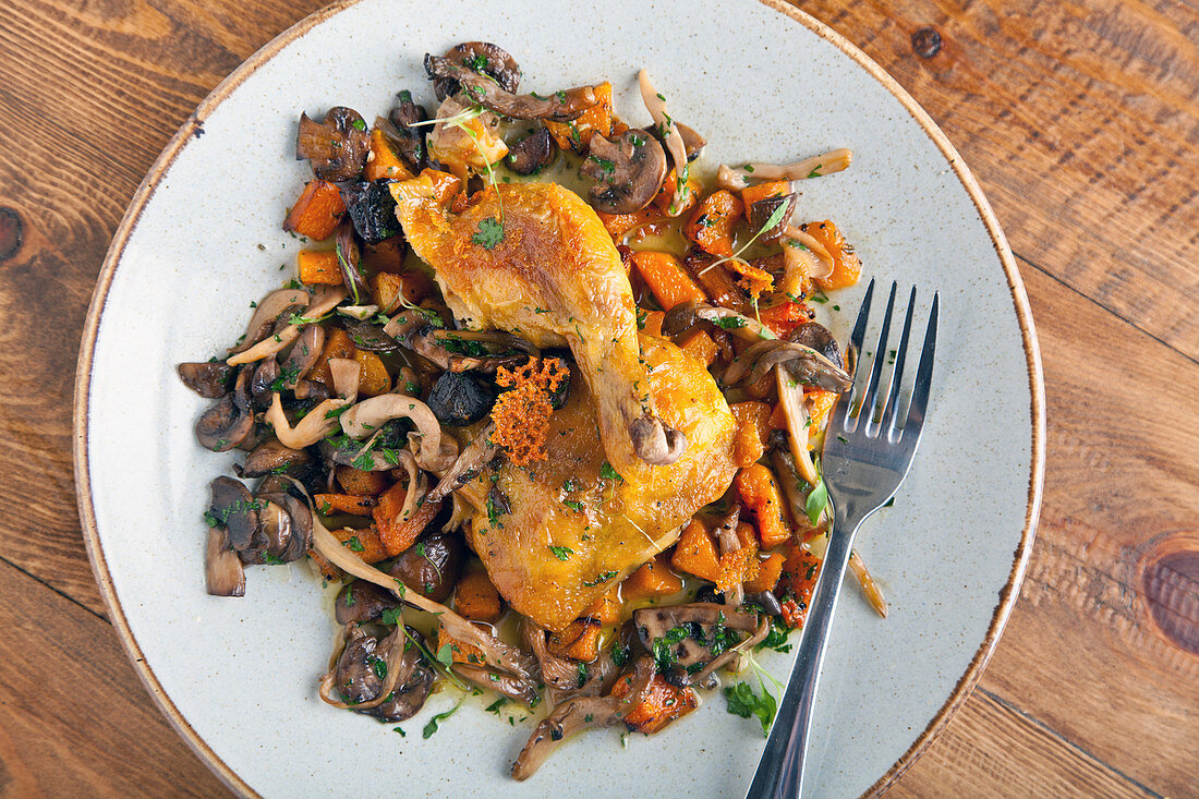 Fried chicken on the bone with mushrooms and carrot