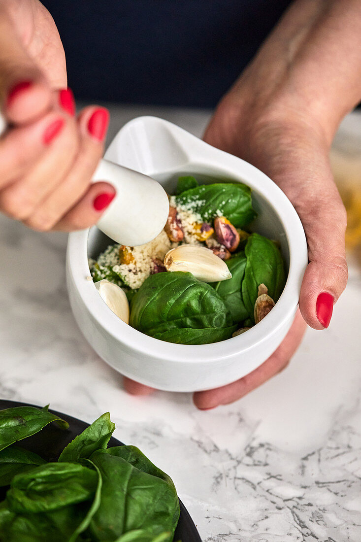 Ingredients for basil and arugula pesto in the pestle