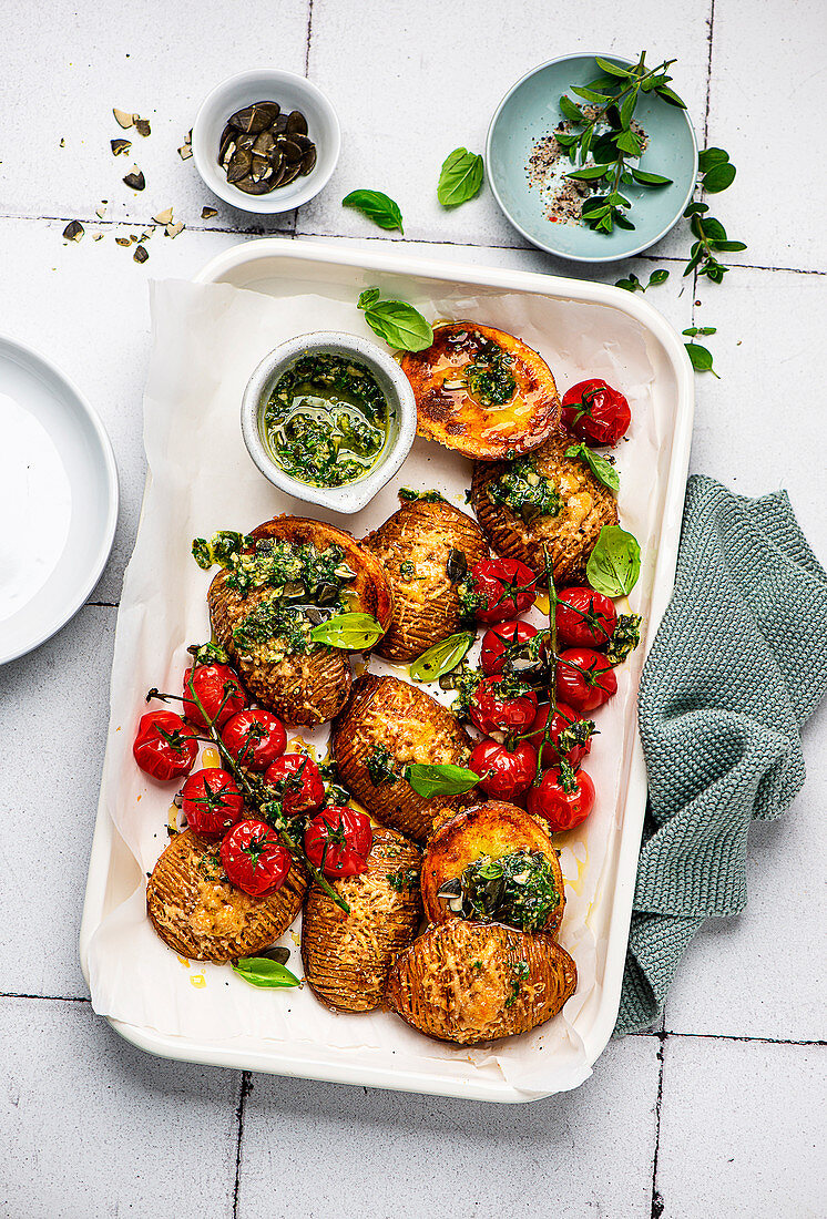 Hasselback potatoes with pesto and baked tomatoes
