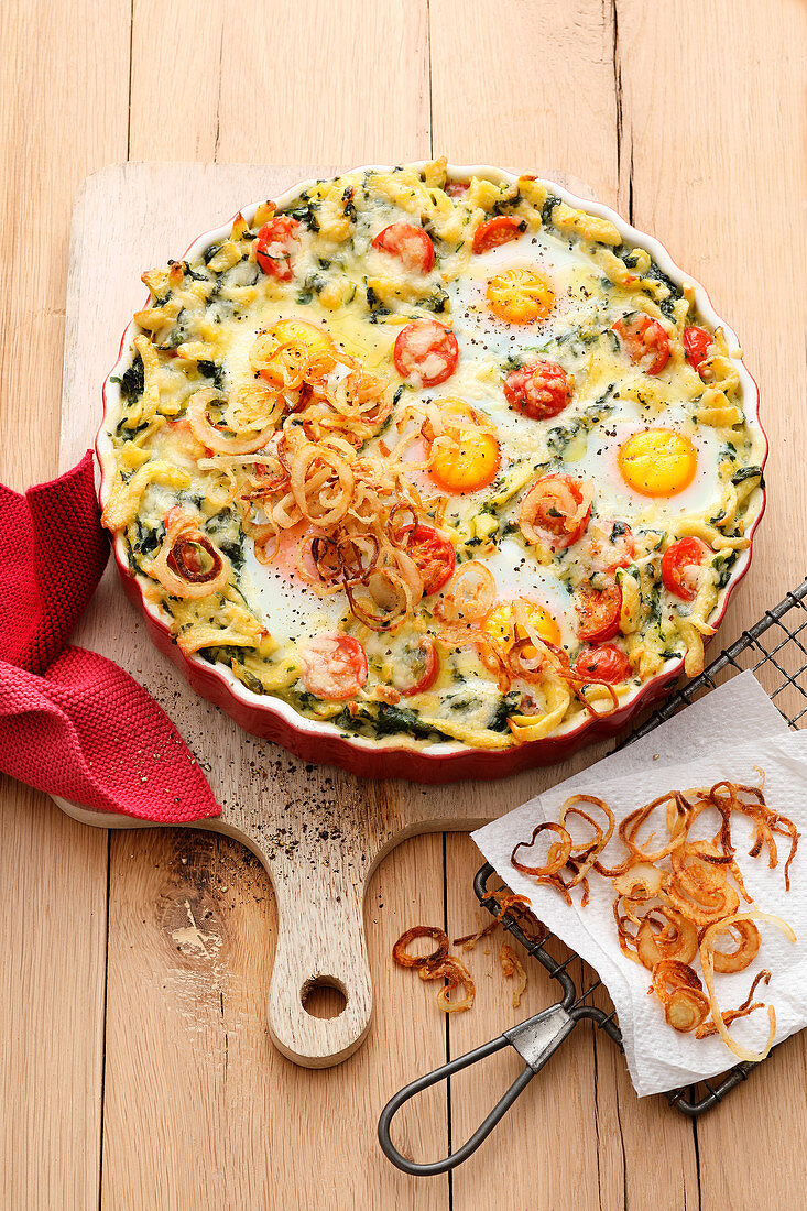 Spinach spaetzle casserole with eggs and fried onions