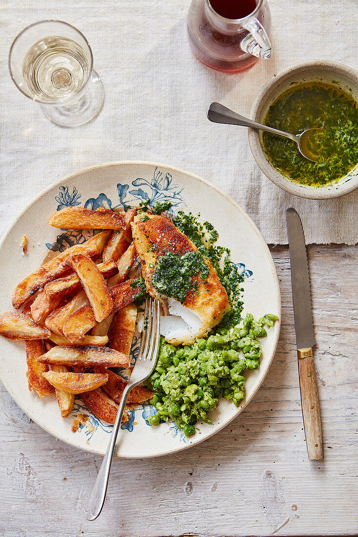 Crispy cod and kiev butter, best-ever oven chips, smashed minted peas