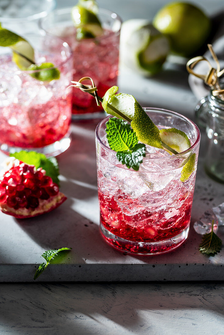 Pomegranate and raspberry gin fizz with mint and lime