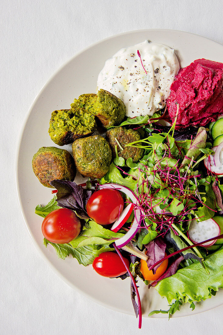 Green pea falafel with dips and salad