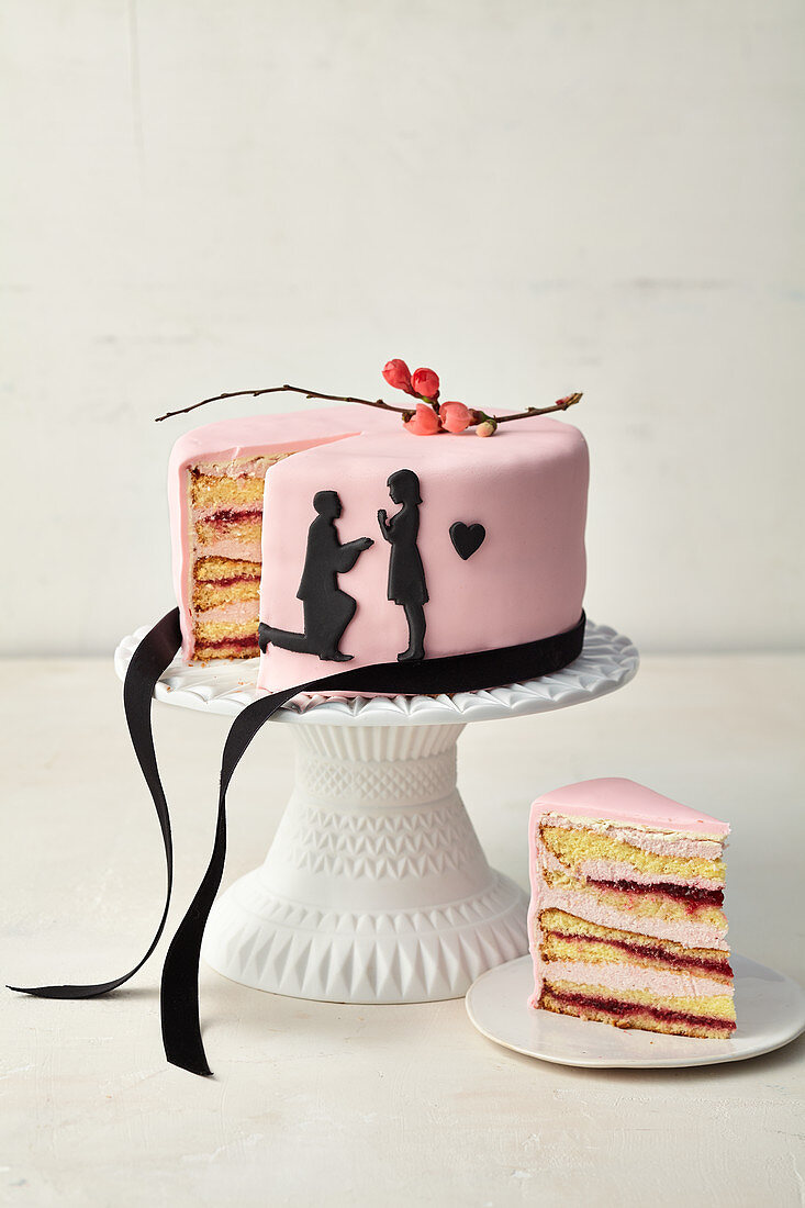 Pink wedding cake with black paper cut tattoos