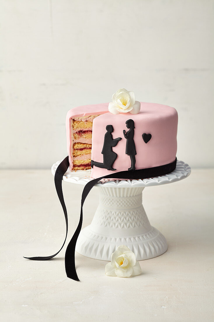 Pink wedding cake with black paper cut tattoos