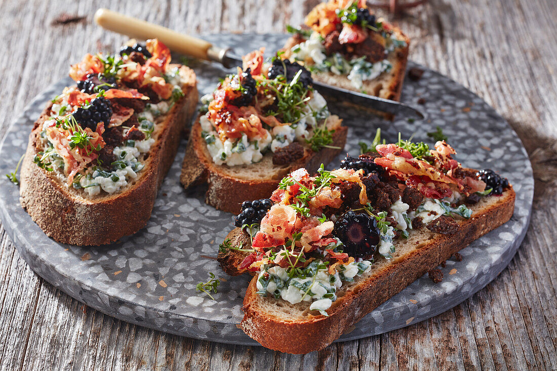 Sourdough bread with herb cream cheese, bacon and blackberries