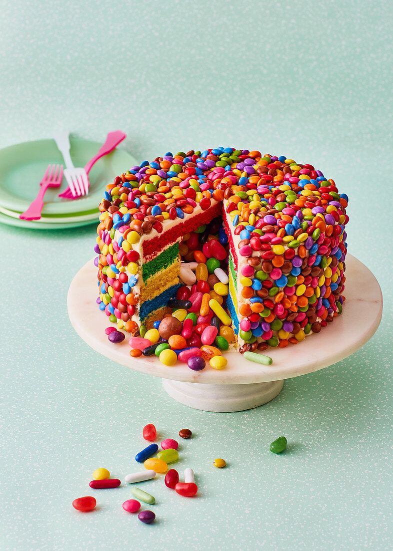 Colorful piñata cake with sweets