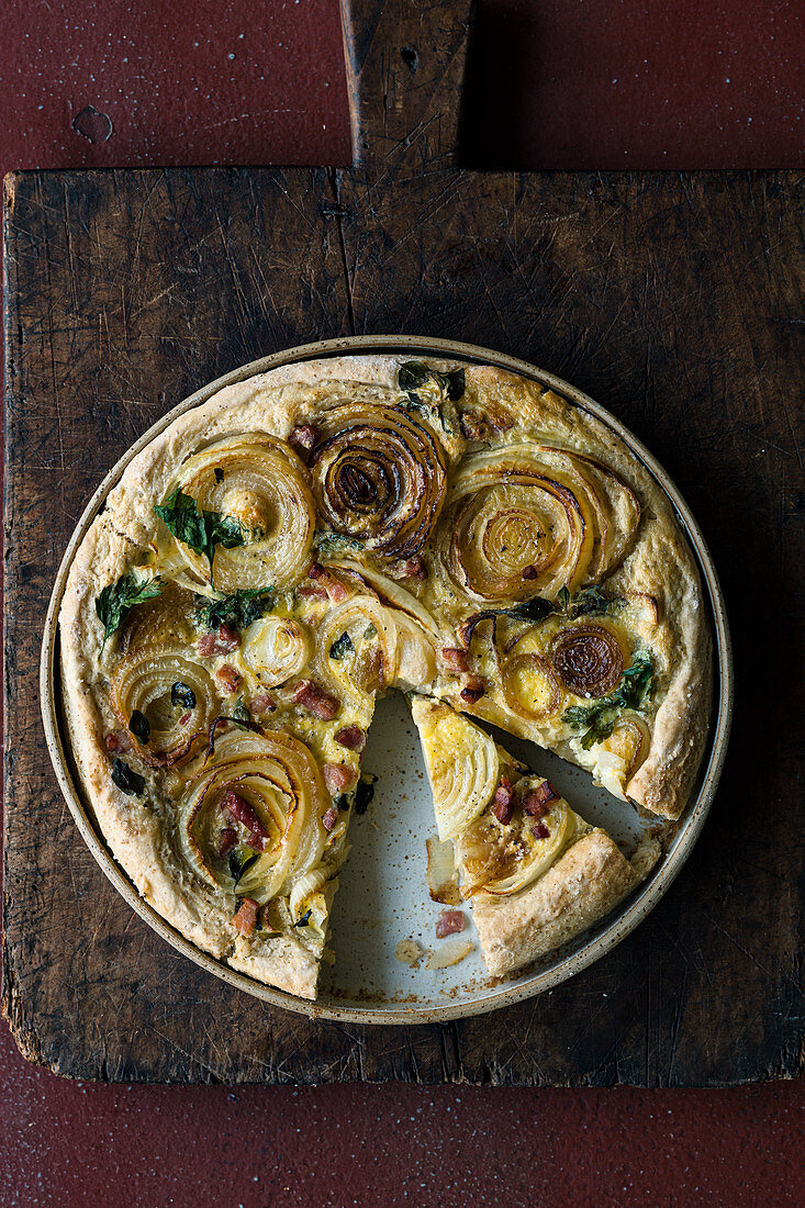 Onion cake with a sour cream topping and smoky bacon