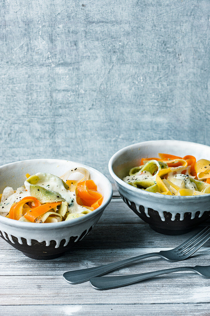 Colourful vegetables and tagliatelle with a creamy cheese sauce