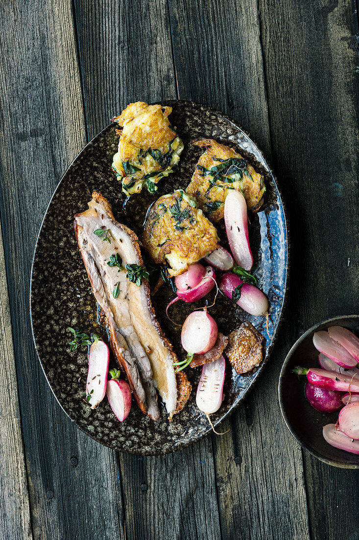 Pork belly with potato cakes and caramelised radishes