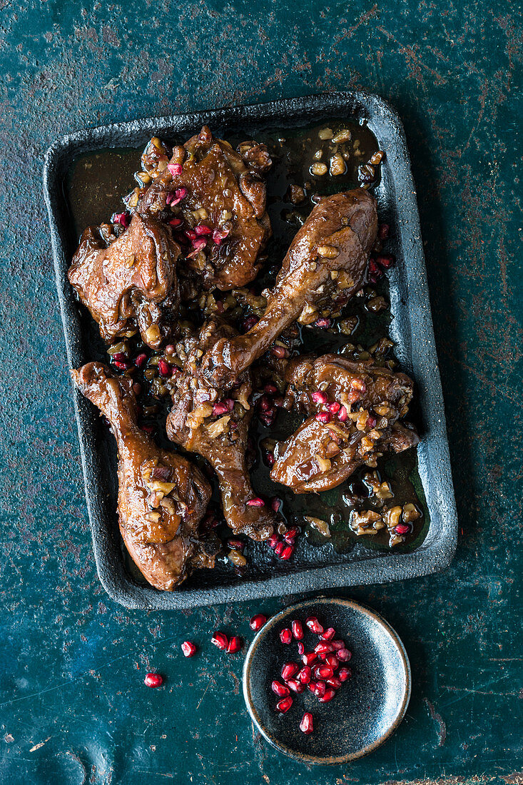 Braised duck legs with walnuts and pomegranate seeds