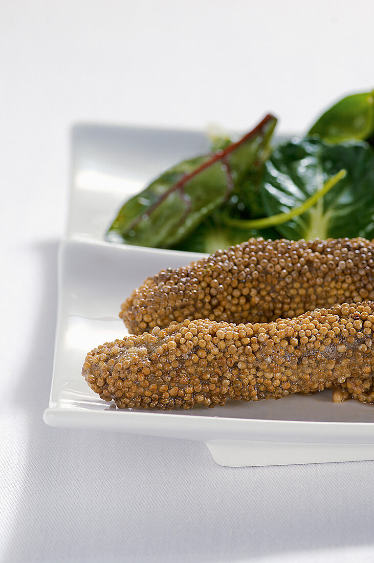 Lamb fillets baked in mustard seeds with salad