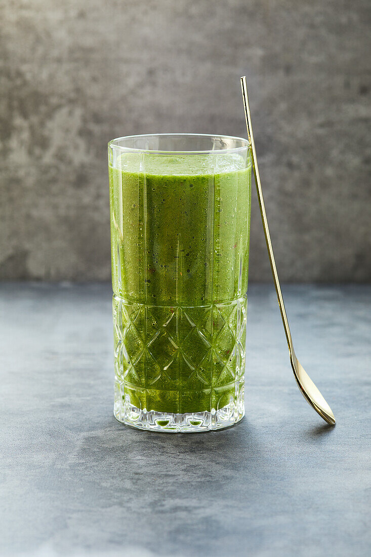 Green smoothie with apple, banana, orange, cucumber and spinach