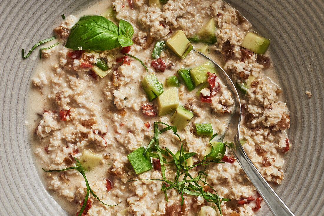 Hearty spelt porridge with avocado, tomatoes and soft apricots