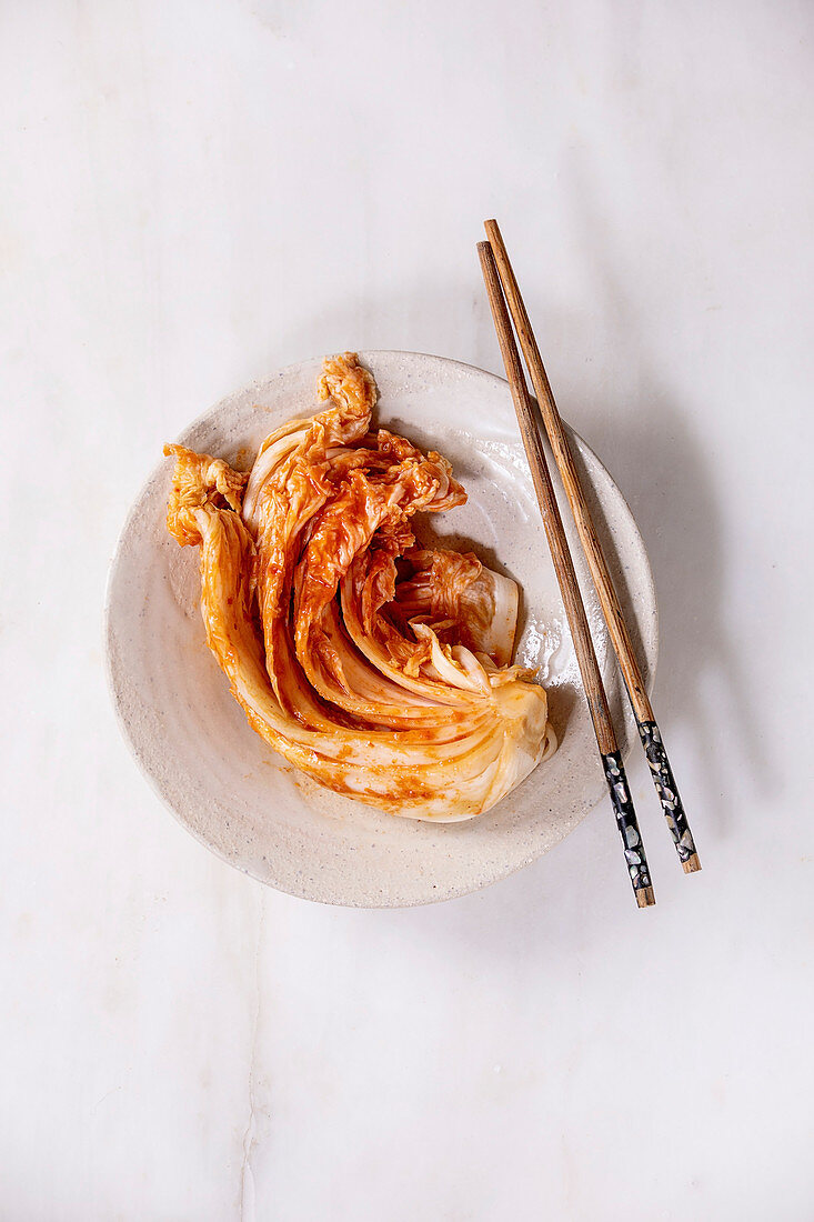 Korean kimchi cabbage on a plate with chopsticks