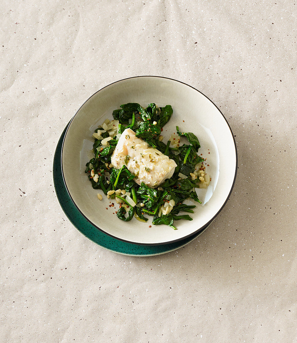 Steamed cod with spinach and pine nuts