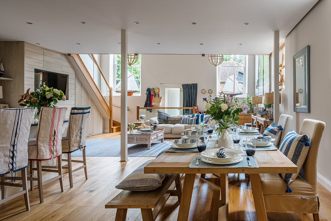 Table in the open living room in maritime nautical style