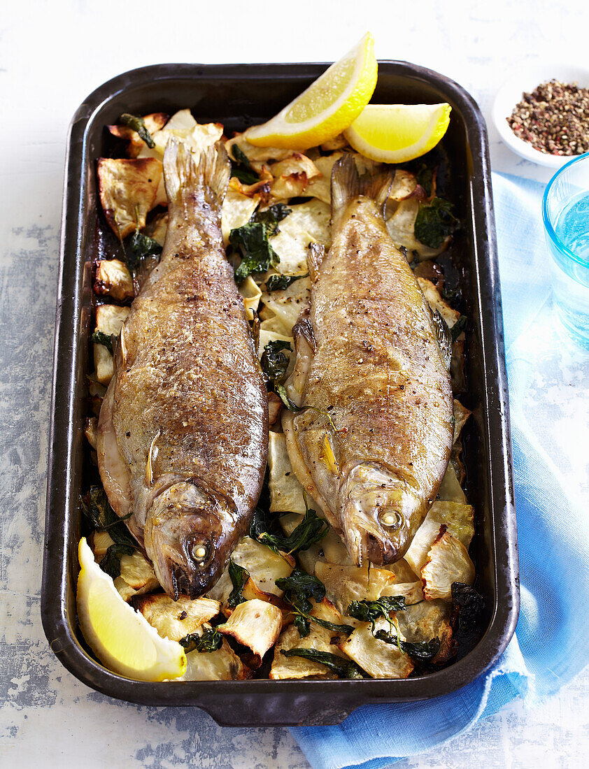 Baked trouts with celery and spinach