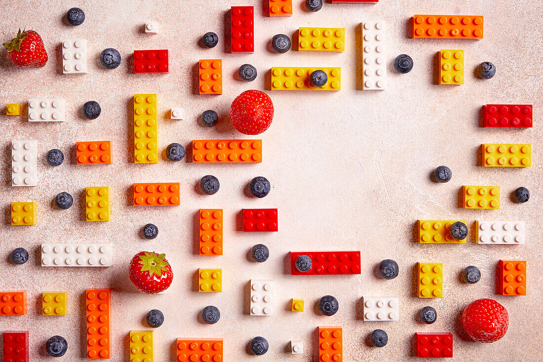 Blueberries, strawberries and colourful Lego bricks