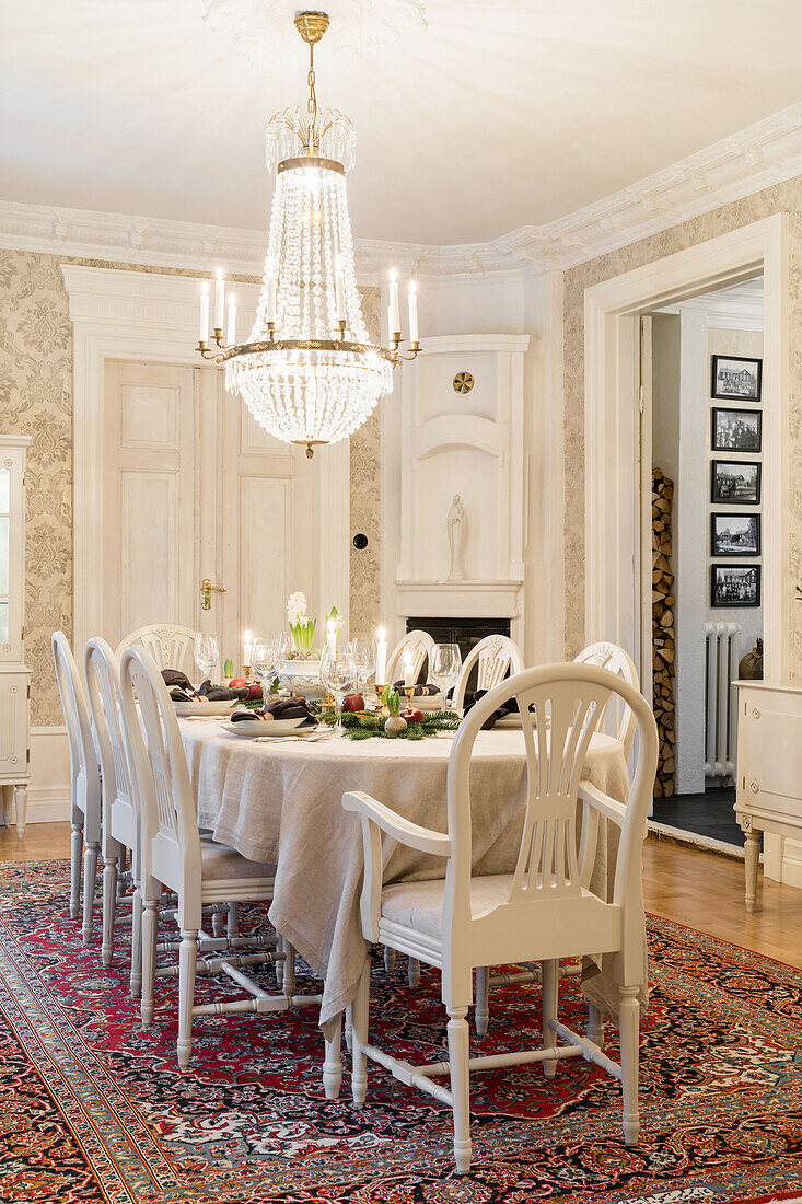 Festively set, bright Christmas table, chandelier hanging above