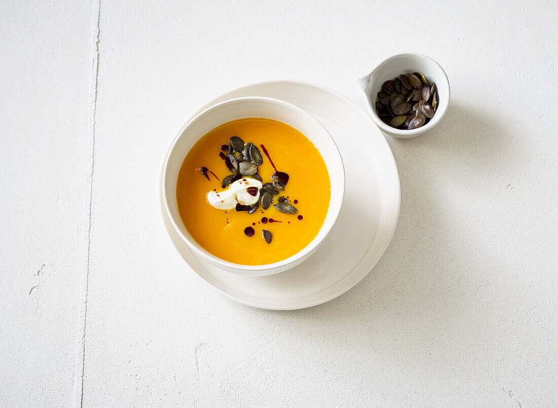 Pumpkin soup with pumpkin seeds and sour cream