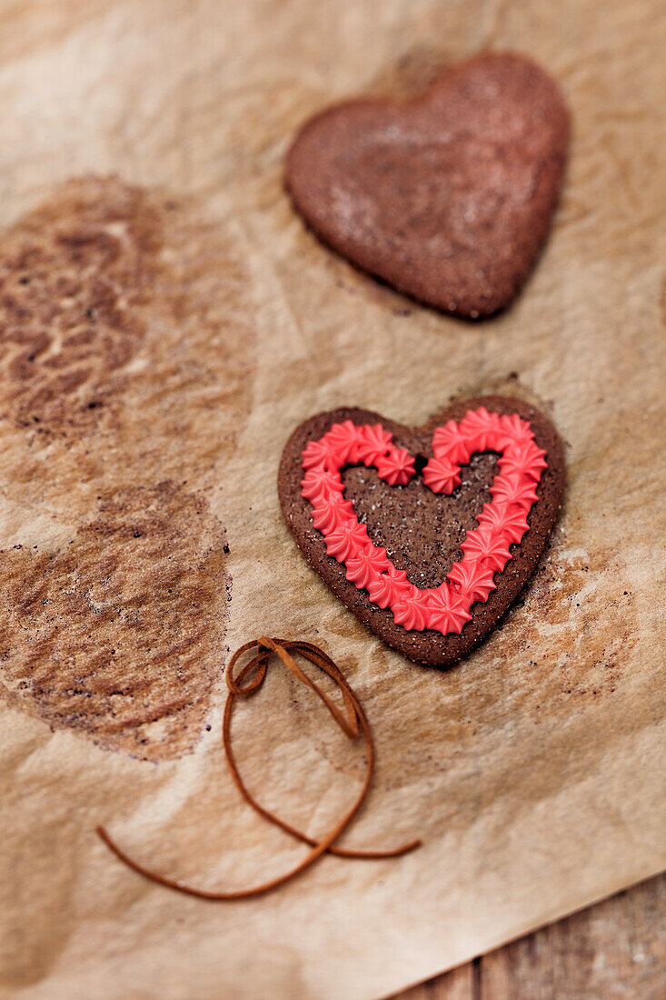 Gingerbread heart with red icing on baking paper