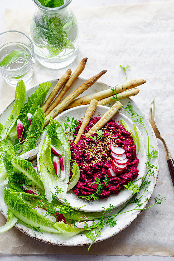 Beetroot hummus with lettuce and breadsticks