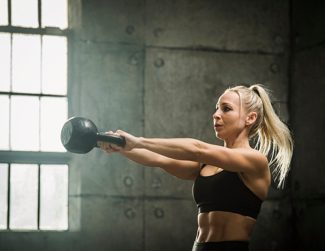 A woman training with a kettlebell