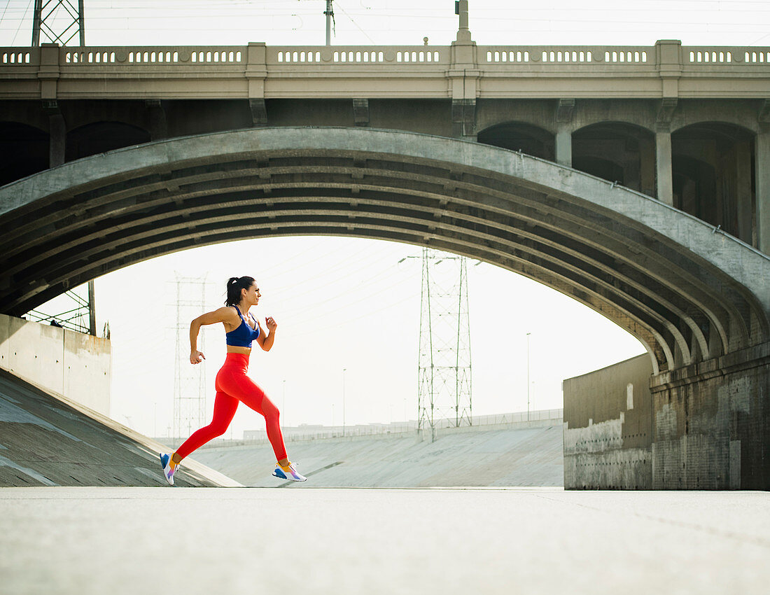USA, California, Los Angeles, Sporty woman jogging in urban setting