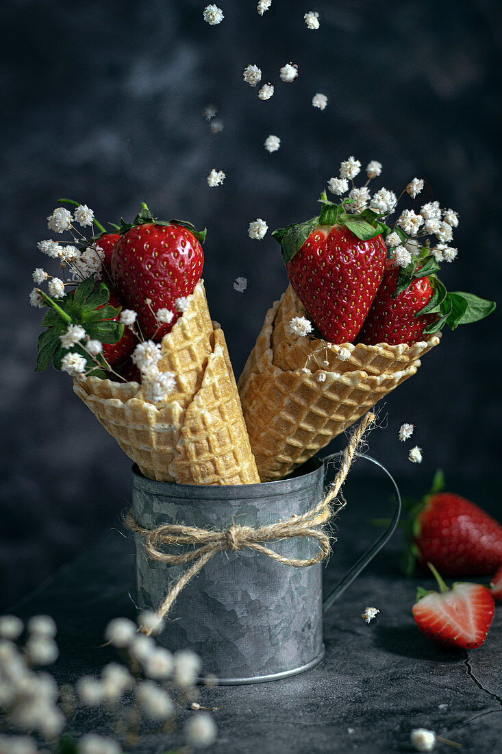 Strawberries with flowers in waffle cones