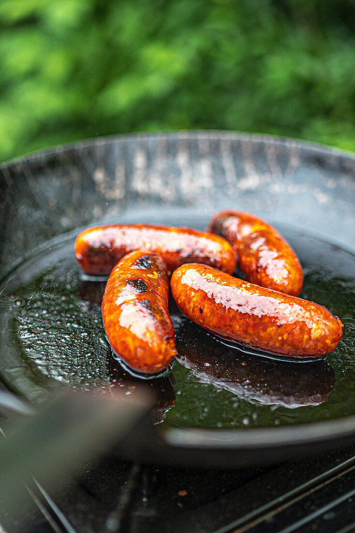 Chorizo roasted in a grill pan on a barbecue