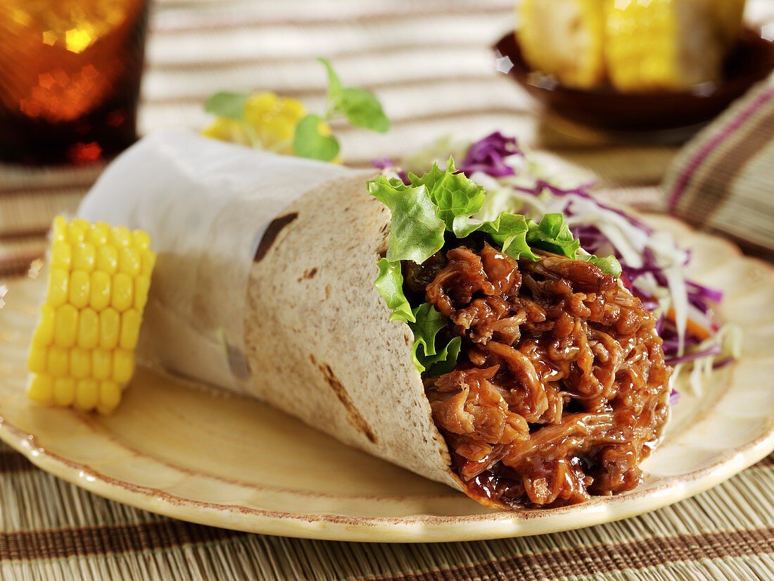 Shredded BBQ beef in grain tortilla wrap with corn and cole slaw