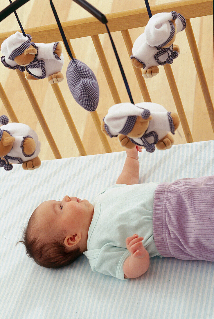 Baby lying in a cot