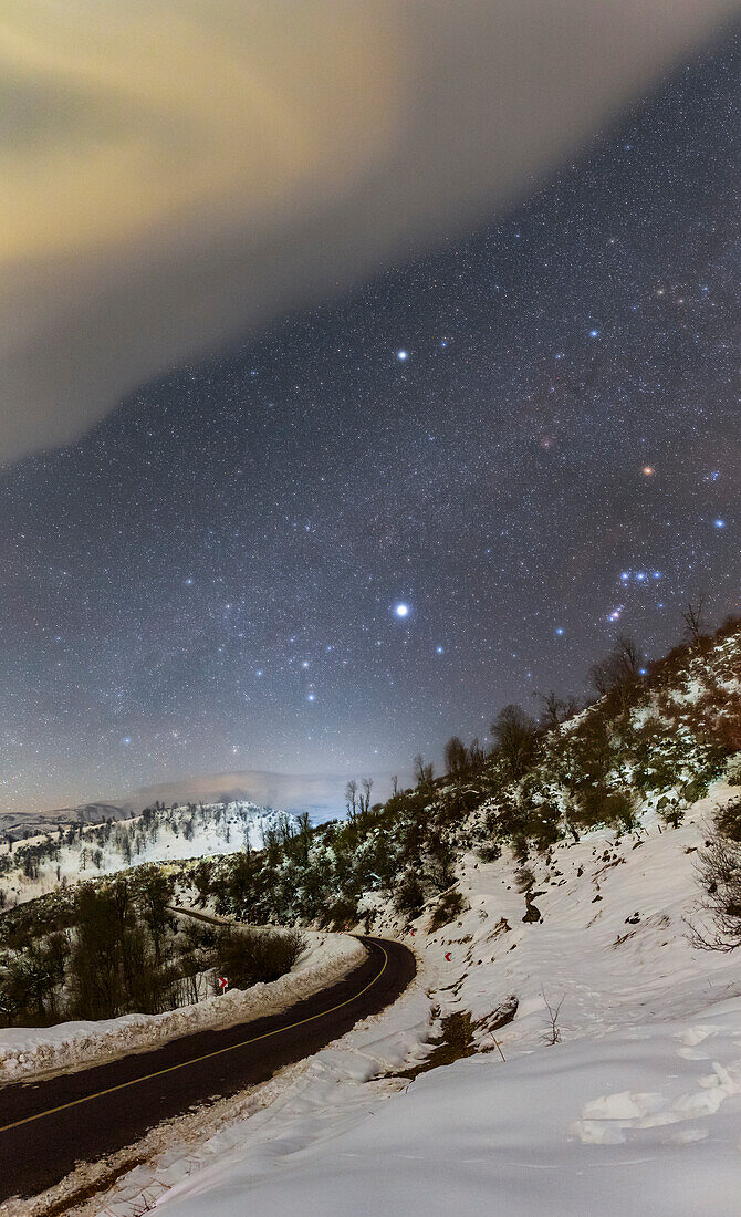 Winter constellation over snow-covered Mountains